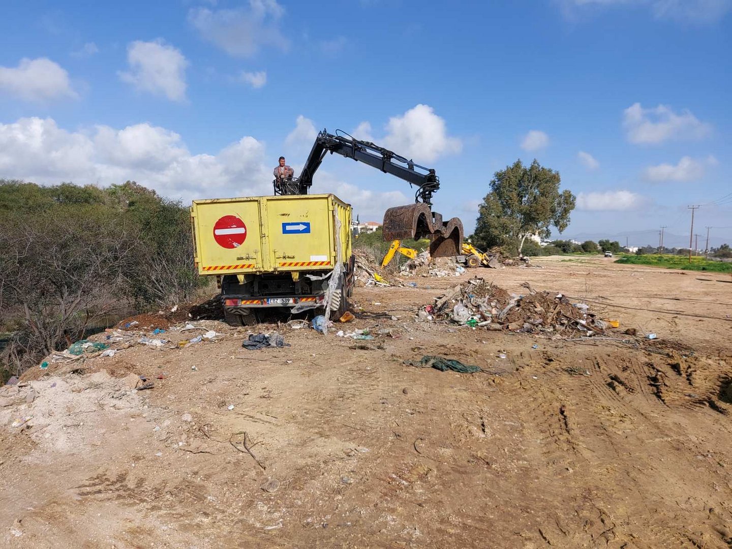 image People ignoring green point, still dumping in riverbed