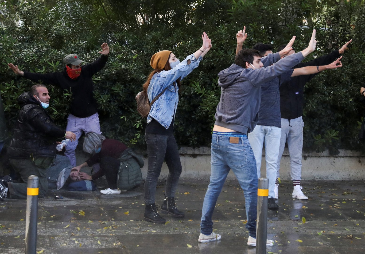 protesters and activists shout to stop the police from using a water cannon during a rally against corruption and covid 19 restriction measures, in nicosia