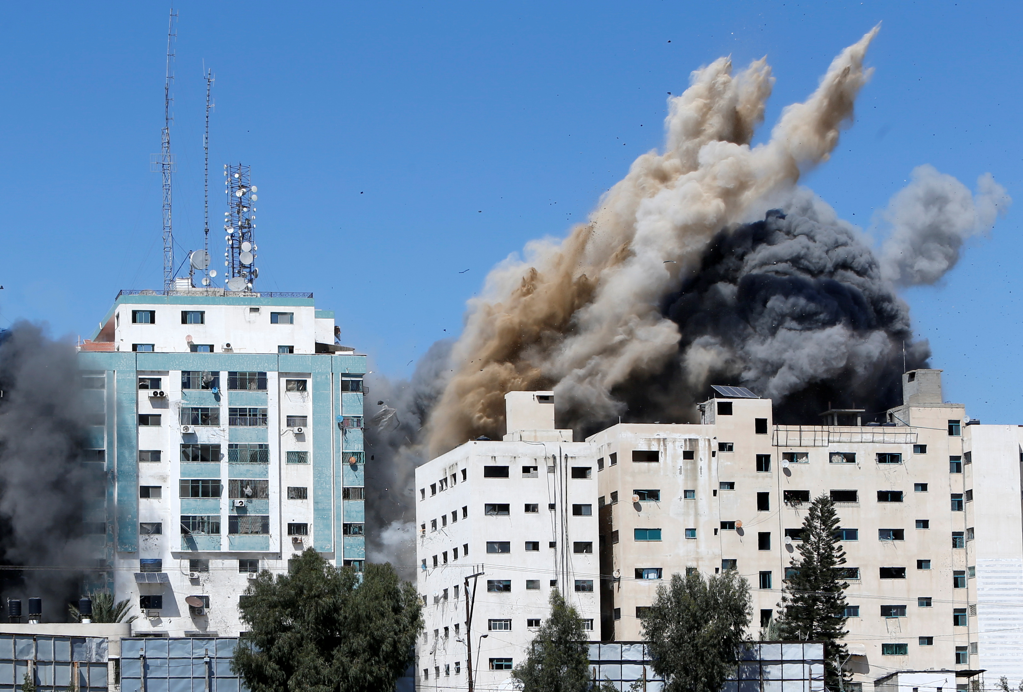 image Gaza tower housing AP, Al Jazeera collapses after missile strike