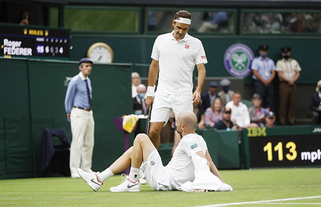 image Federer survives big scare as Mannarino retires injured