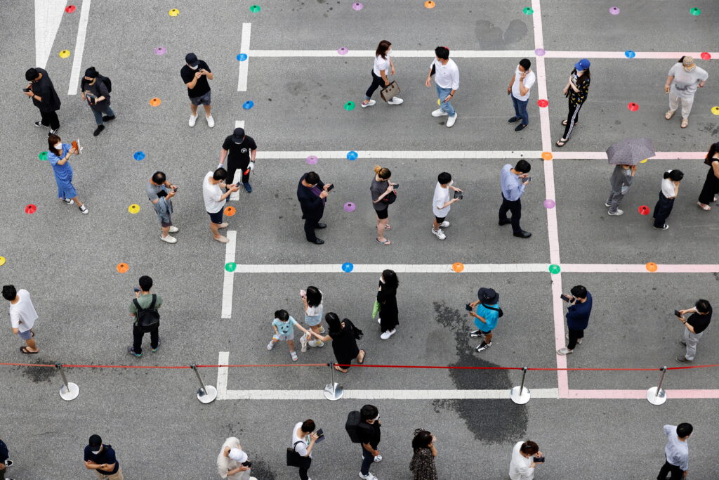 people wait in line for a coronavirus disease (covid 19) test at a testing site which is temporarily set up at a public health center in seoul