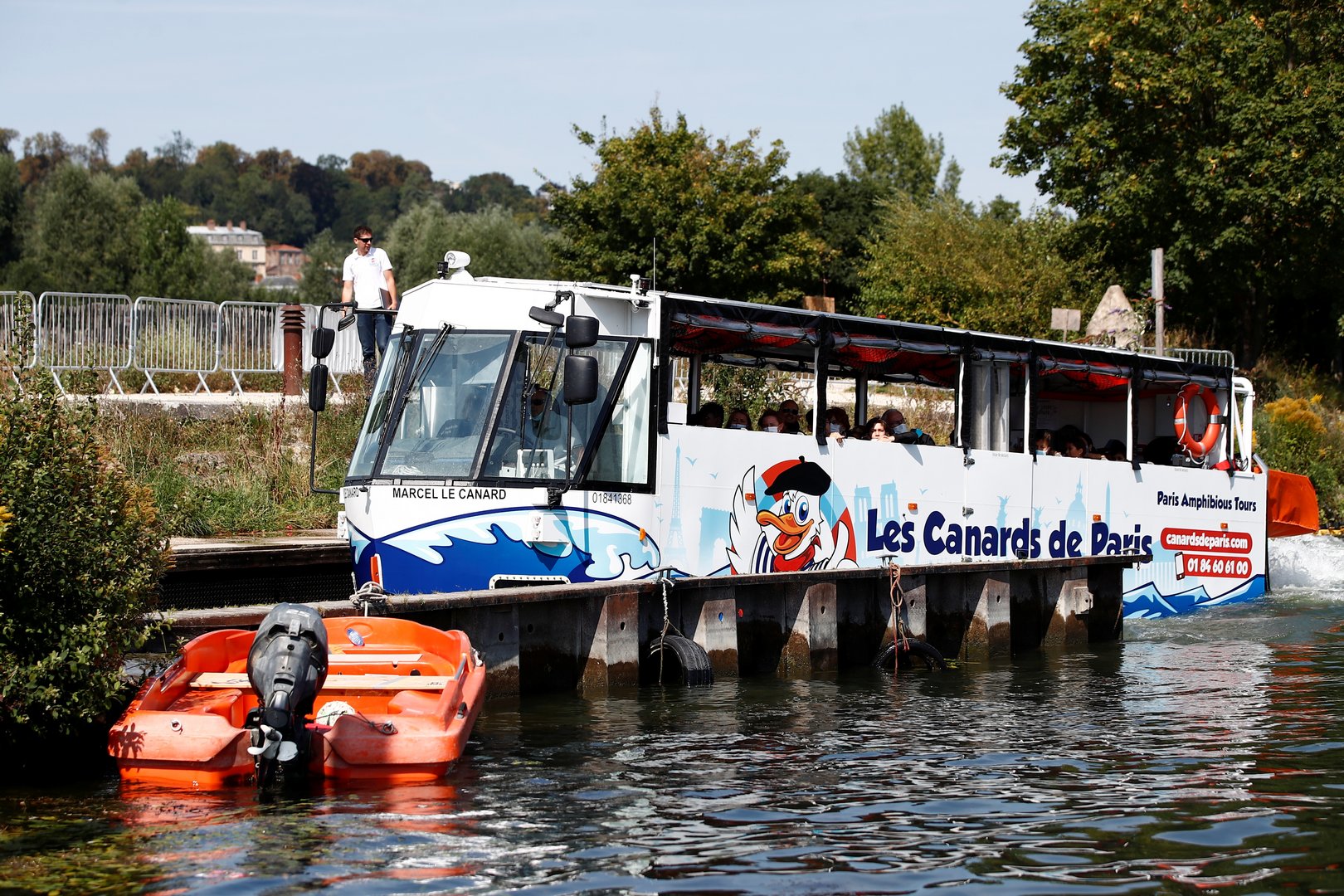 an amphibious bus comes out from the seine river in sevres near paris