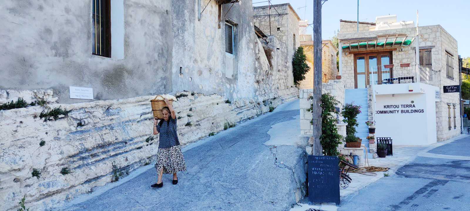 feature paul lambis a woman carries her laundry to the washing site