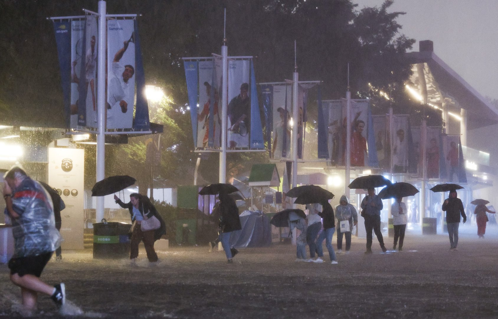 image Six dead in record breaking rain in New York, California wildfires rage on