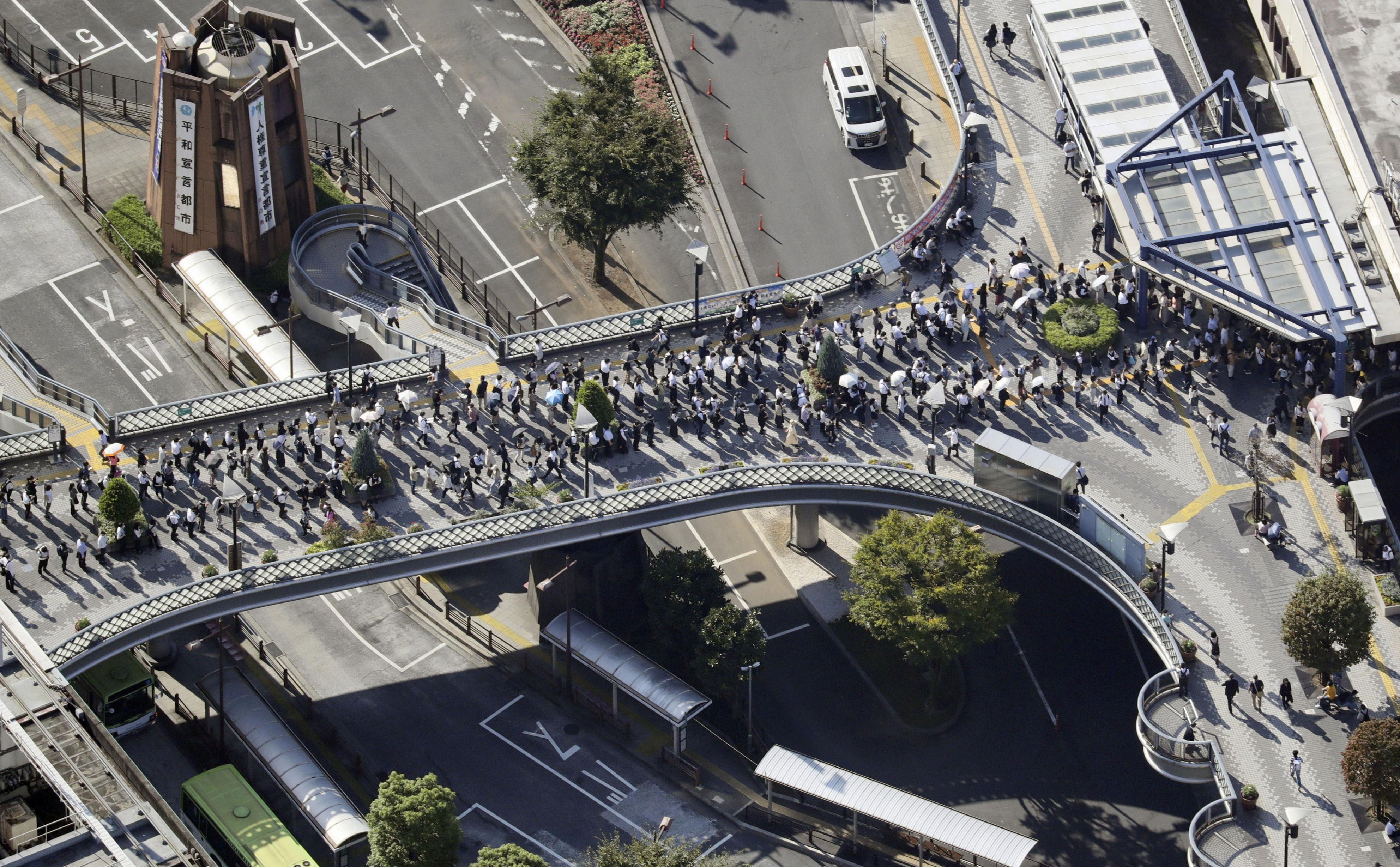 image Tokyo trains crowded but little other damage day after strong quake