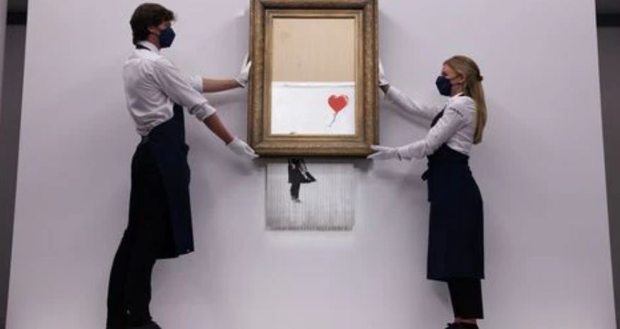 image Half-shredded Banksy fetches $25.4 mln on return to Sotheby&#8217;s