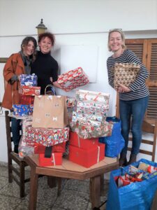 karen pekris (right) collecting packed shoeboxes from catherine bergerdaisy kyriakidou (left) at the tree of life centre, larnaca
