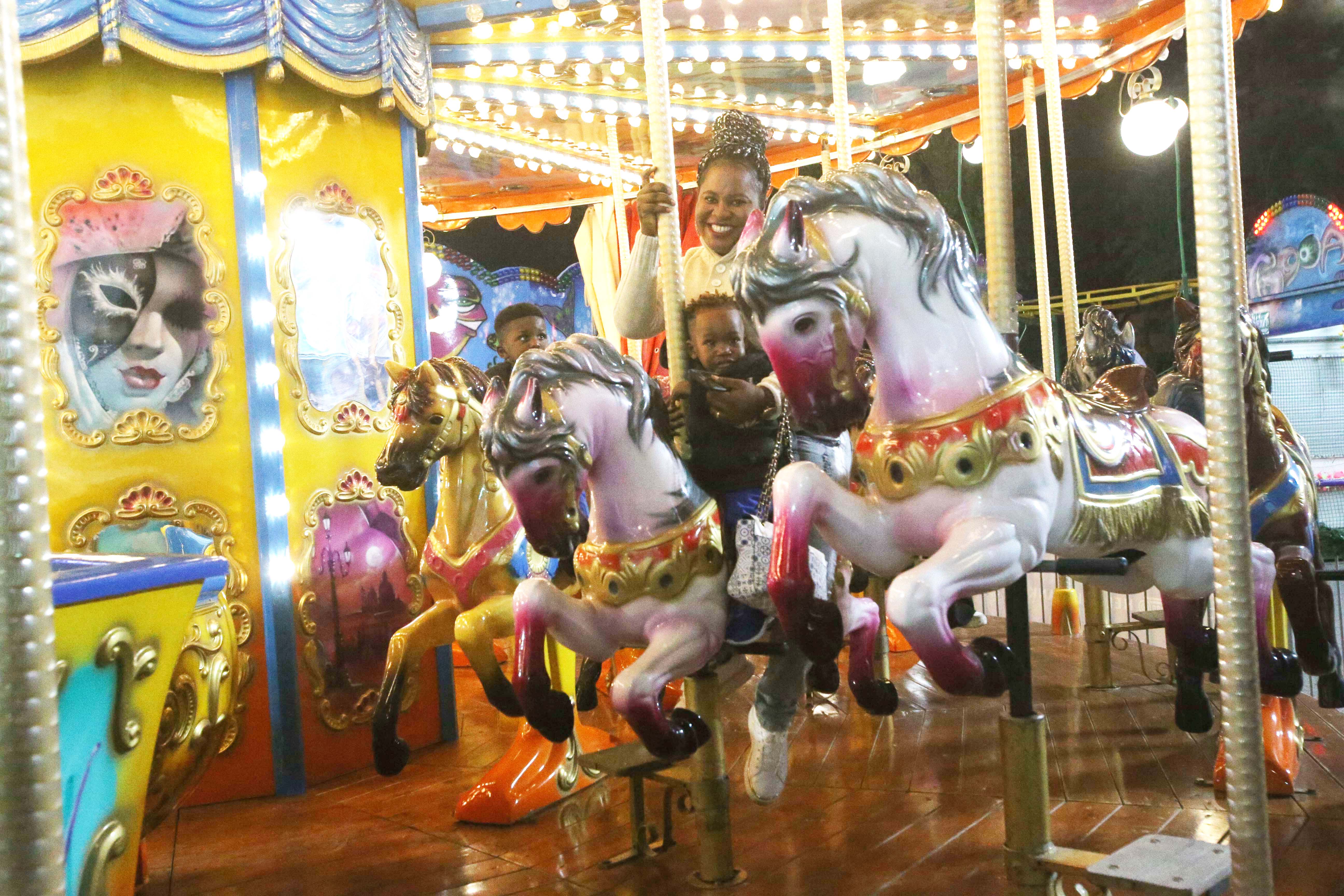 feature nick children ride on the carousel with their mum