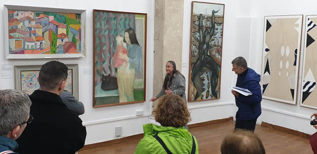 rhea bailey and yiannis toumazis in front of her painting