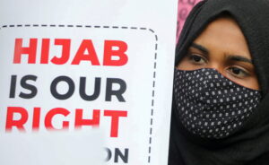 a muslim student holds a placard during a protest by muslim students federation (msf) against the recent hijab ban in few of karnataka’s colleges, in new delhi