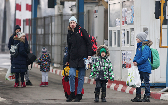 image Clutching plastic bags and suitcases, Ukrainians flee to safety abroad