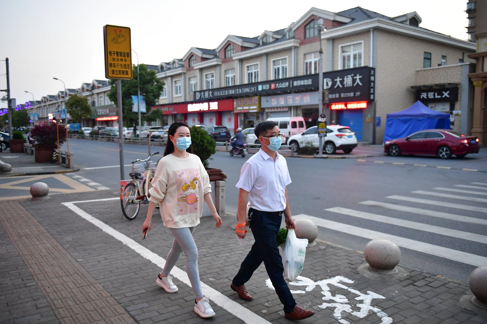 image Some in Shanghai leave home for first time in two weeks, US state reimposes mask mandate