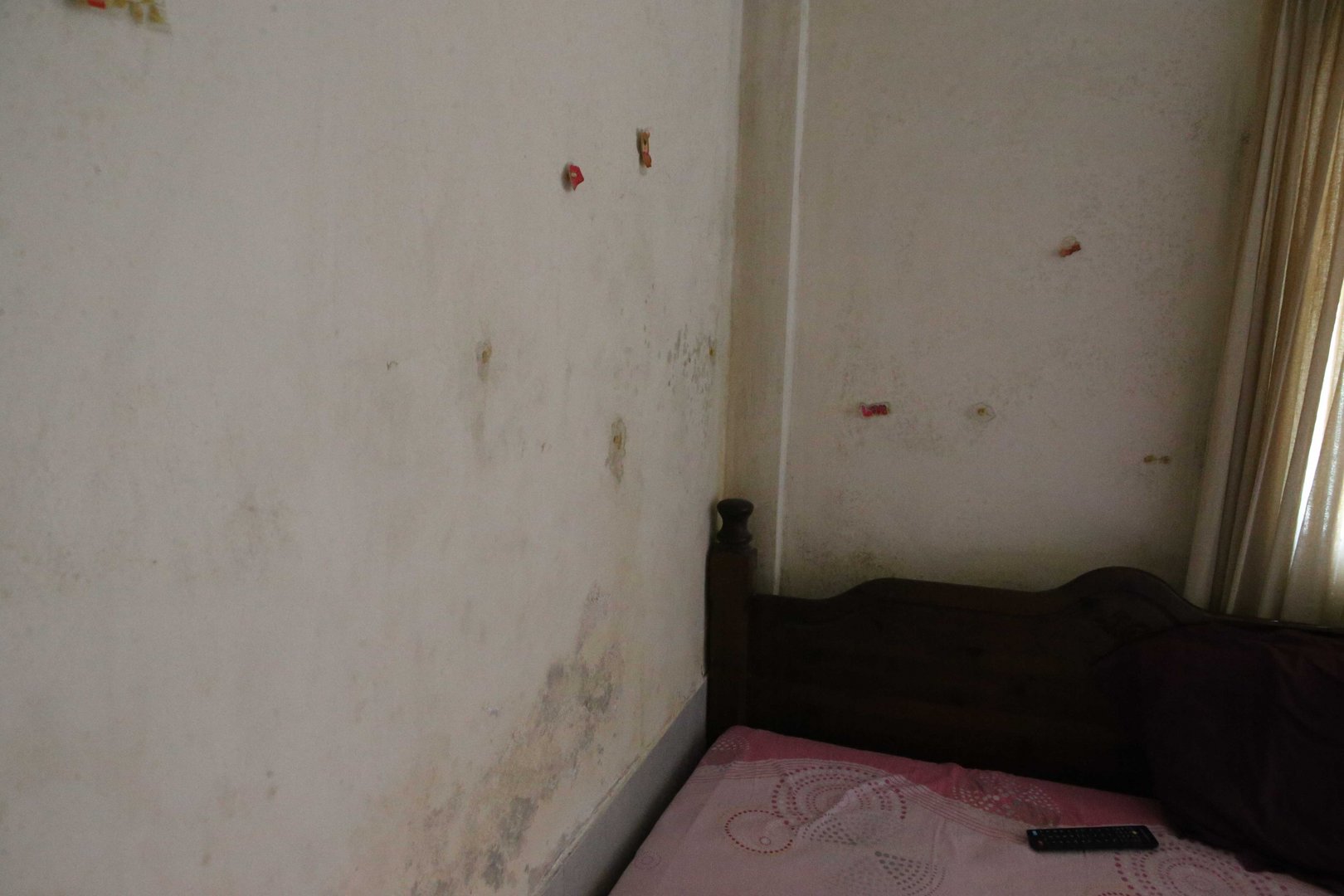 feature theo the walls of the flats are striped with mildew