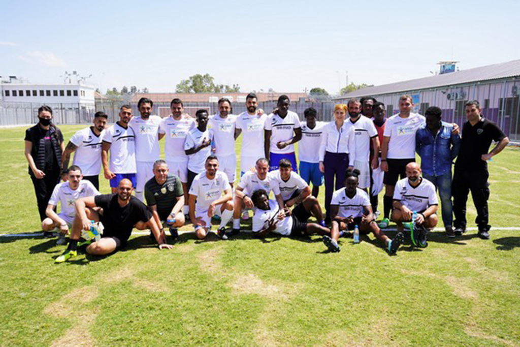 image Footballers join prison inmates for match