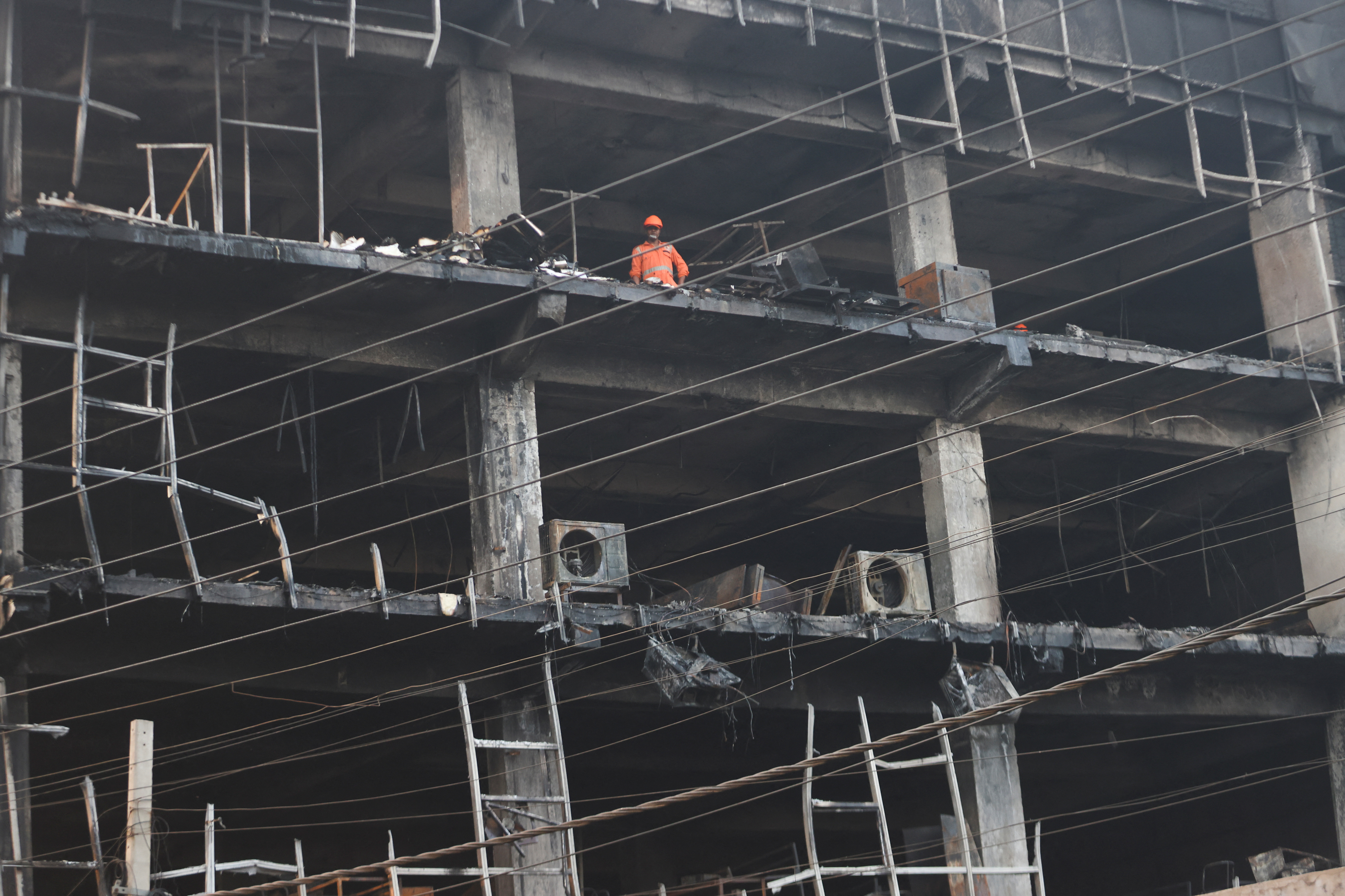 image Building fire kills 27 in New Delhi, police arrest company owners