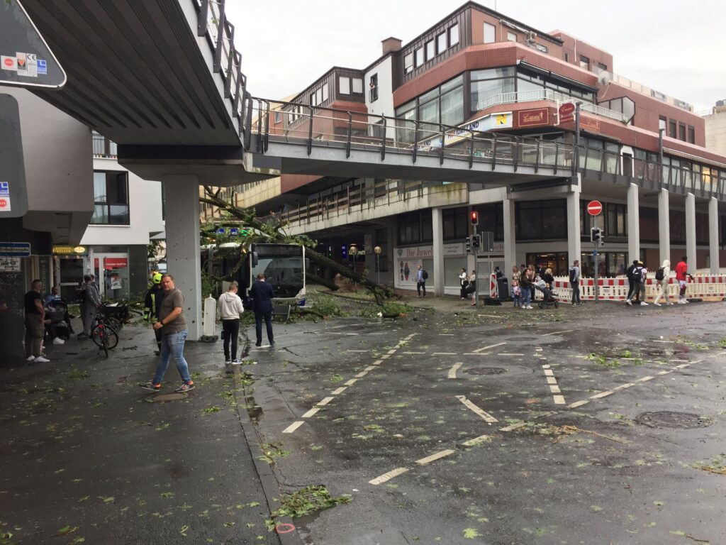 people walk on the streets in the aftermath of a tornado that swept through the town of paderborn