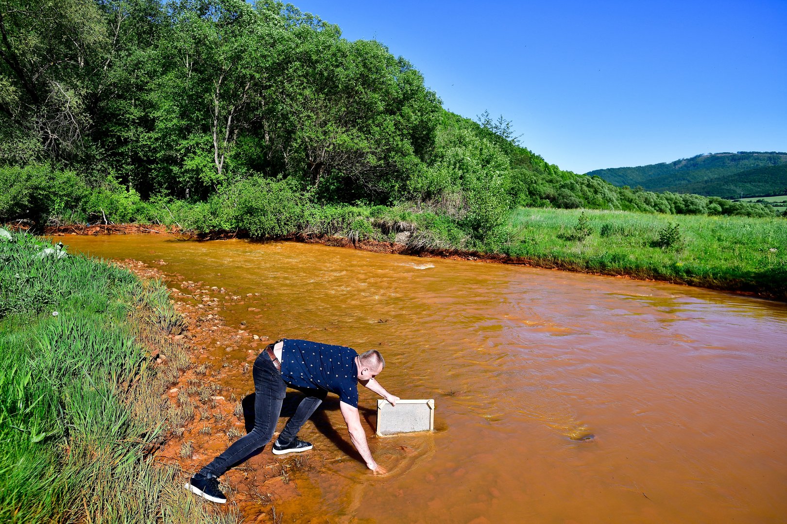 image Slovakia scrambles to stem polluted water that turned Slana River orange