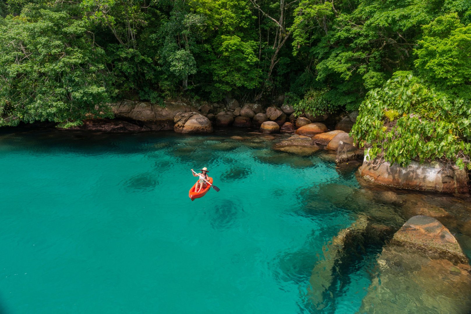 travel2 paddling in the clear waters of paraty