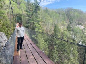 travel sean coyte on a suspension bridge above st anne’s canyon