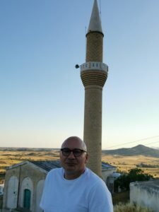 feature agnieszka metin murat on the terrace of his home in platanissos (balalan), behind the village mosque