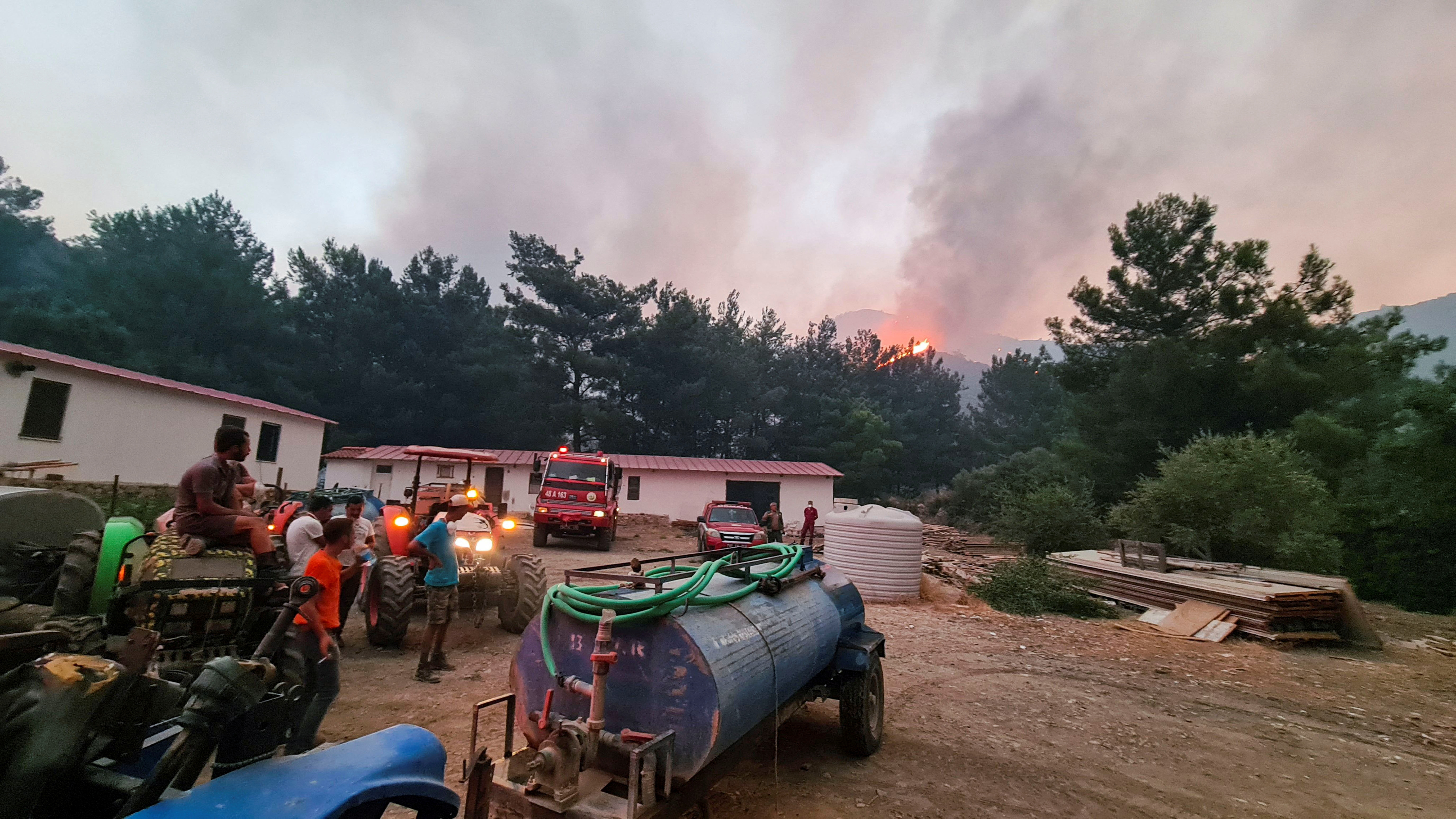 image Firefighters contain wildfire in southwestern Turkey near hotel, residential area (Update)