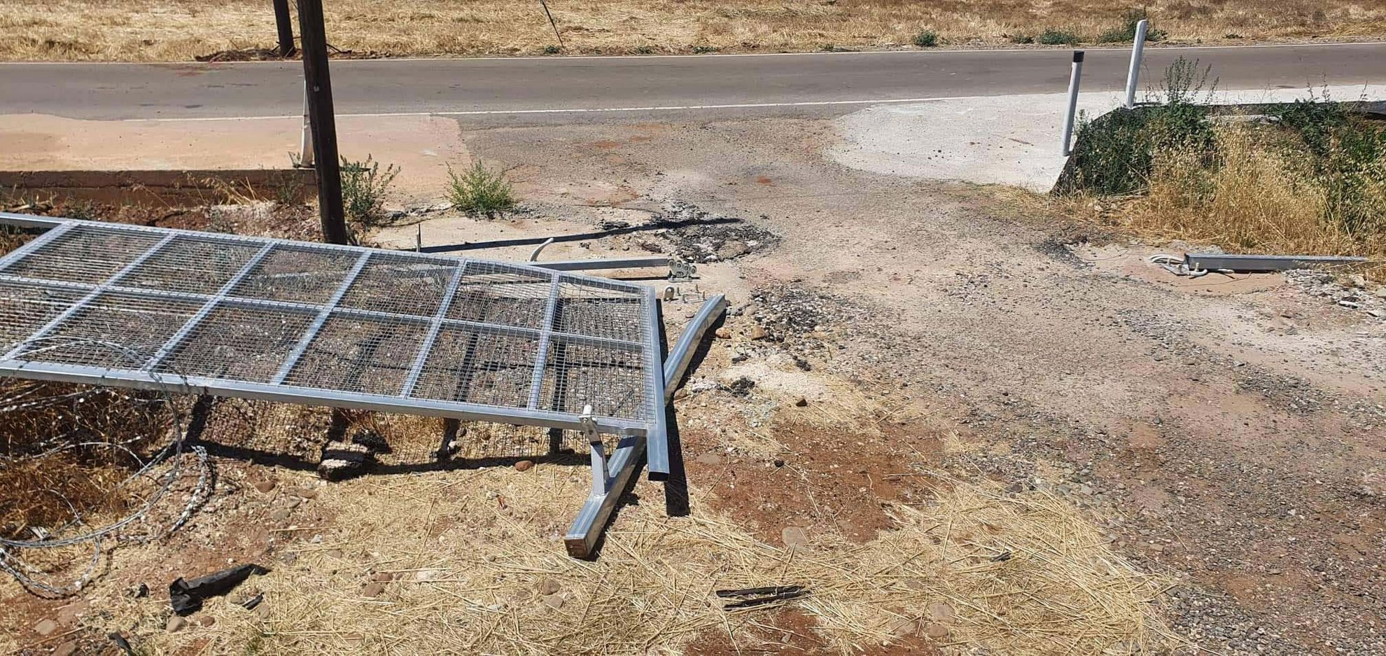 image Gate in buffer zone barbed wire fence knocked down