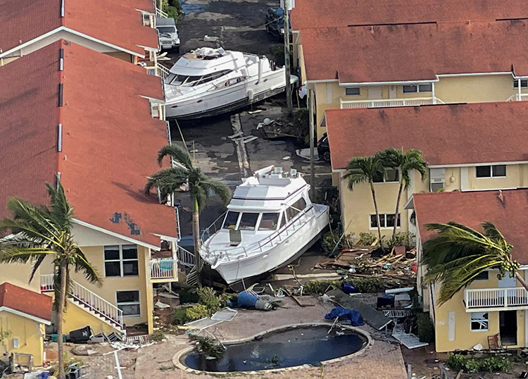 an aerial view of damaged boats after hurricane ian caused widespread destruction in fort myers