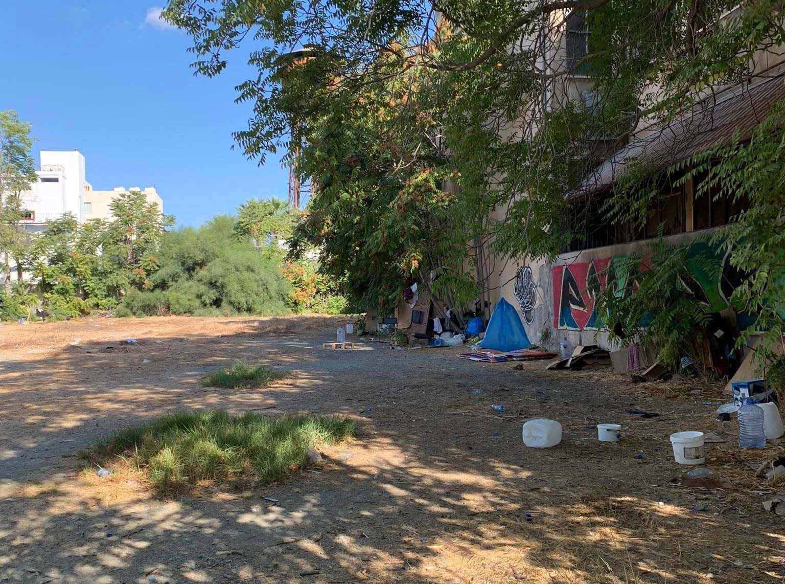 image Migrants set up home in rough ground in central Limassol