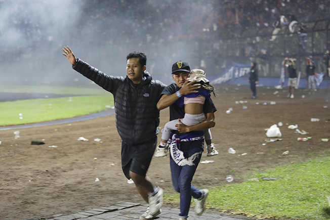 image Fans say tear gas, locked gates led to Indonesian football stampede