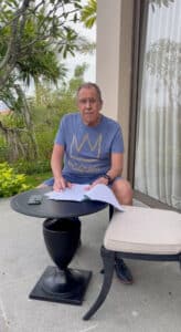 russian foreign minister sergei lavrov reads documents on a patio in bali