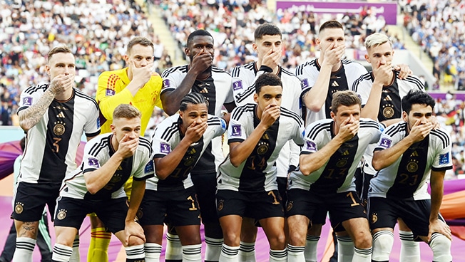 image Germany players cover mouths in team photo amid armband row