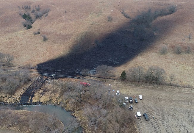 image Residents hold their nose as crews mop up huge US oil spill