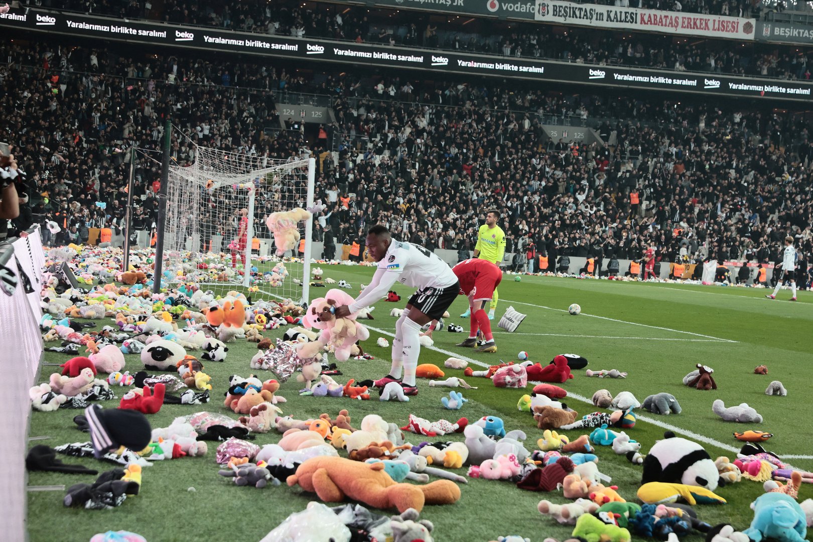 image Besiktas fans throw toys on field for children affected by earthquake