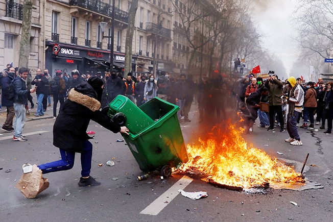 image Embattled Macron heads to China, leaving burning Paris behind