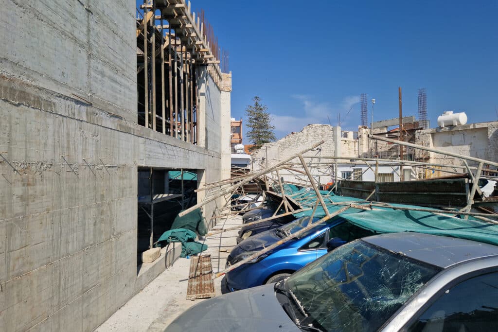 scaffolding, scaffold, damaged cars, building