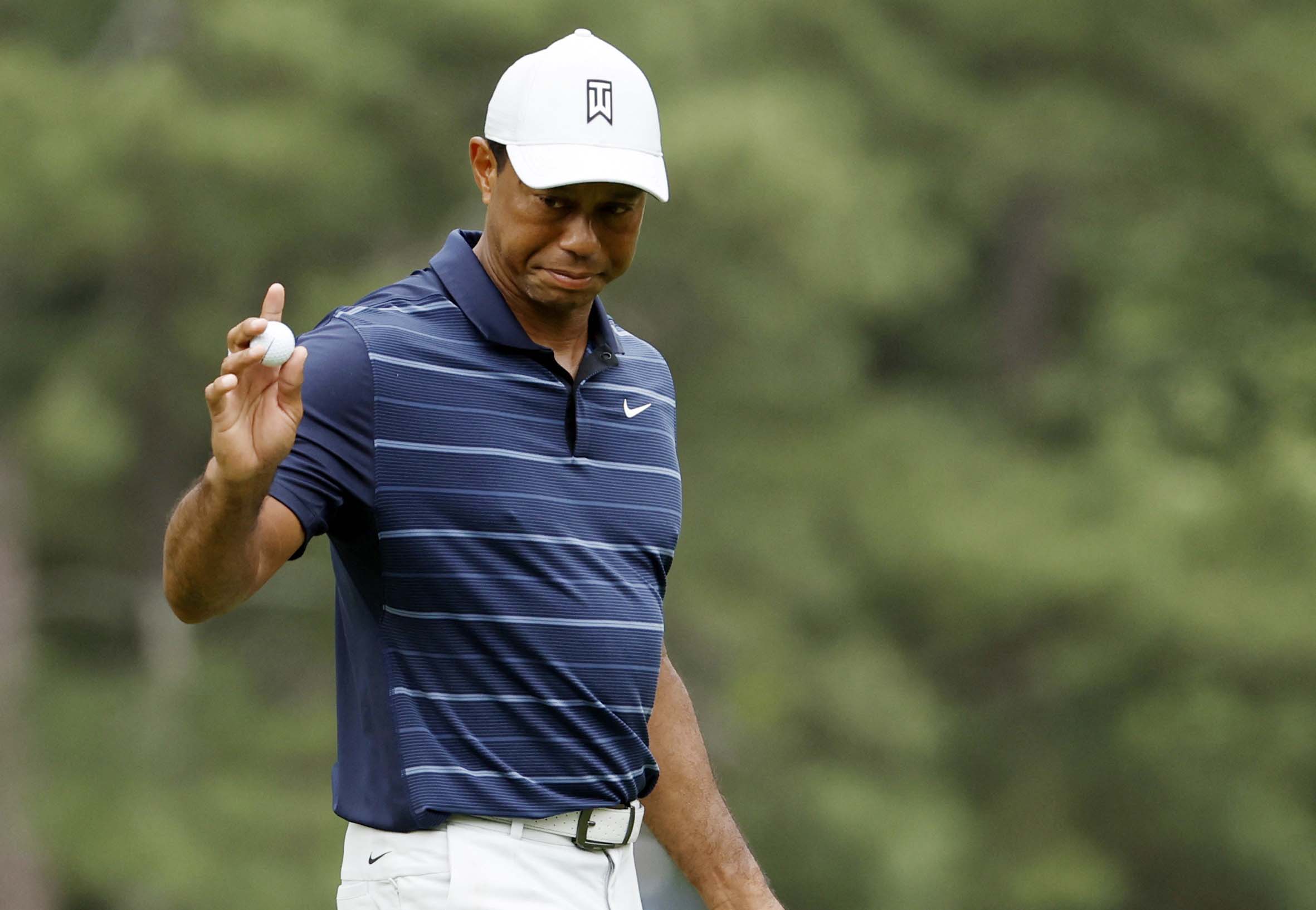image Tiger Woods survives rough finish to make Masters cut