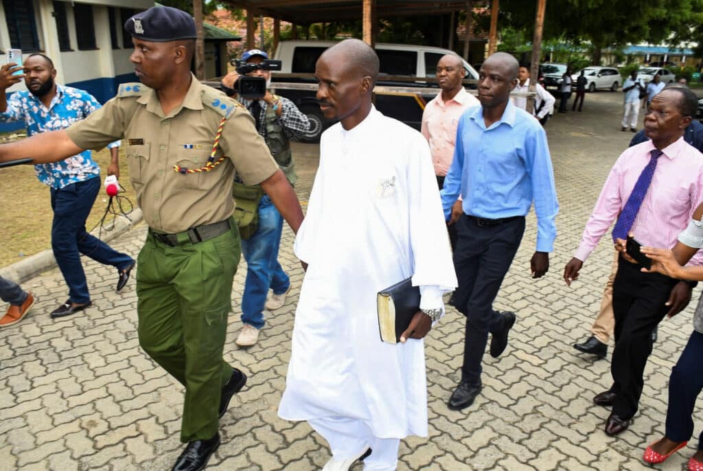 detectives escort ezekiel ombok odero at the police headquarters in mombasa