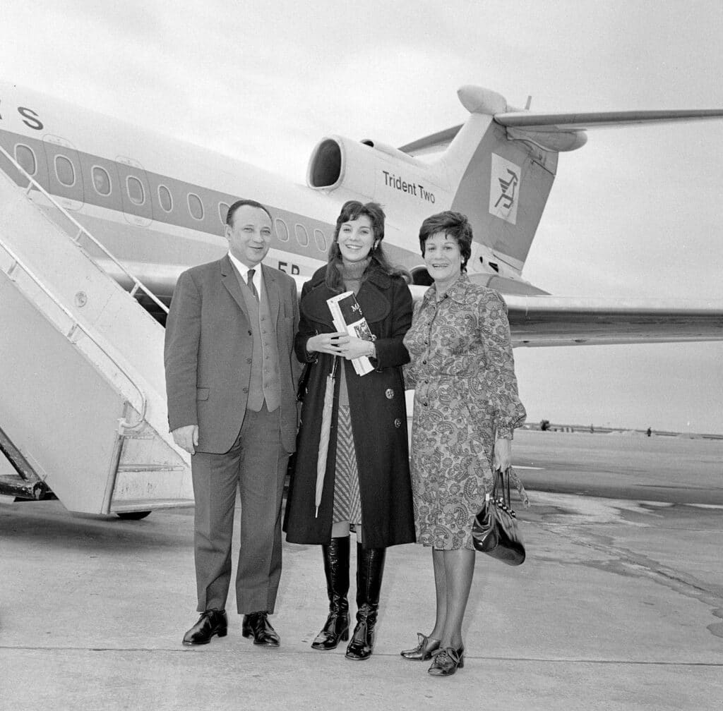 profile as a young woman with her parents at the airport