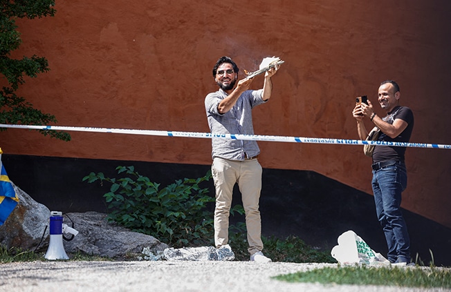 image Protesters burn Koran at Stockholm mosque on Eid holiday