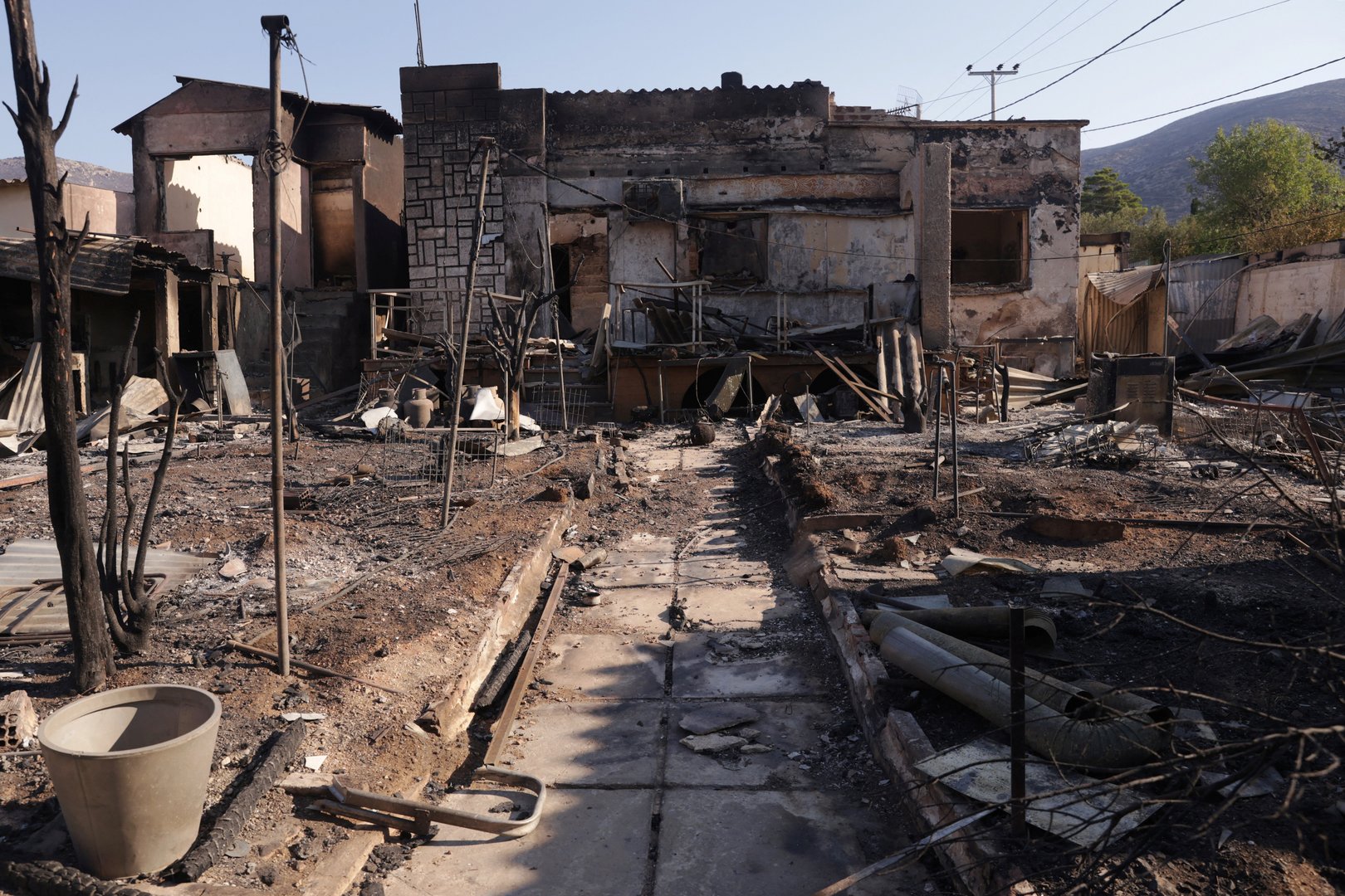image Wildfires northwest of Athens rage into the night, burn homes