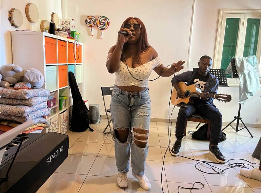 feature malia patricia mbiakop sings to the camera