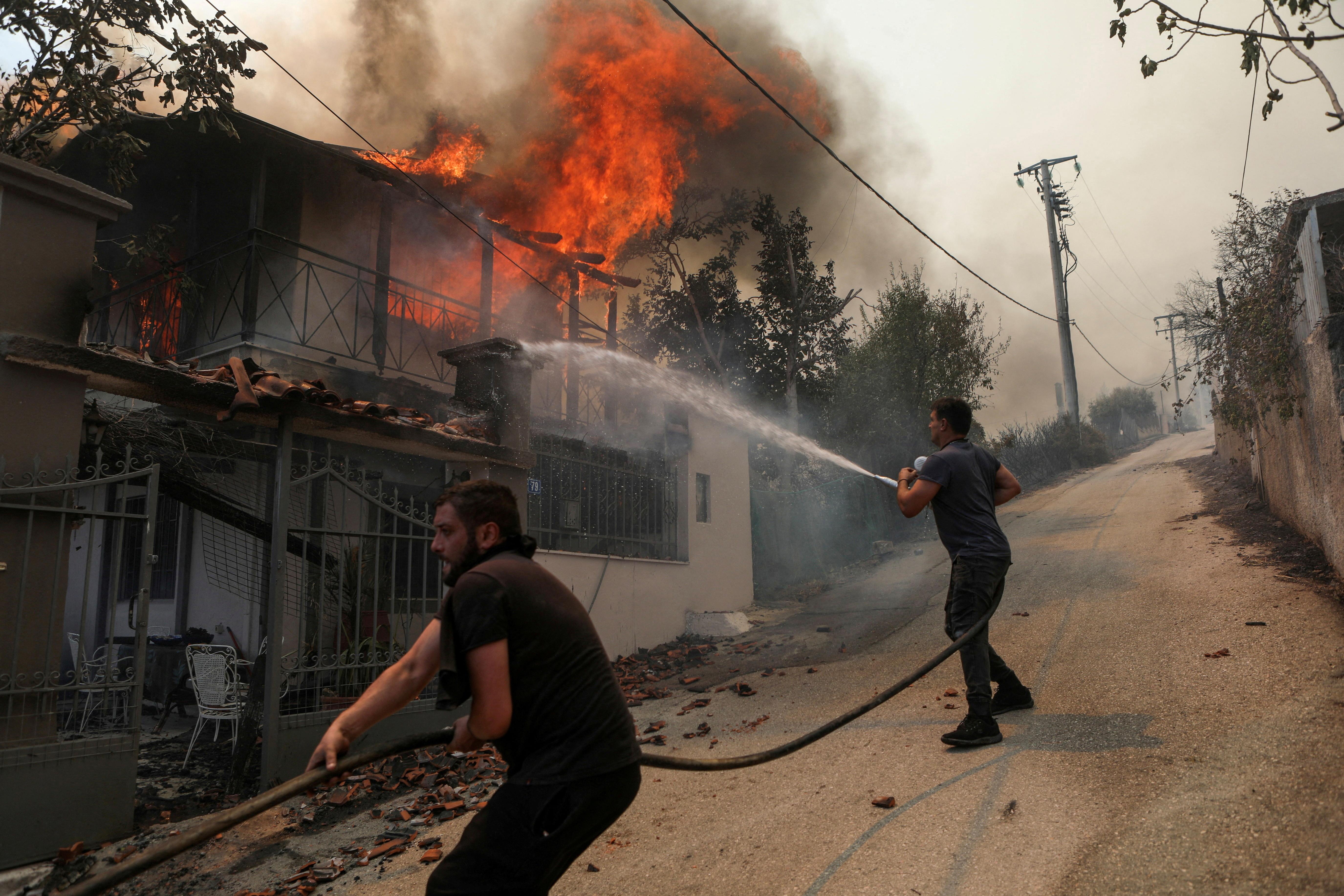 image On a charred migrant trail, Greek firefighters find 19 bodies