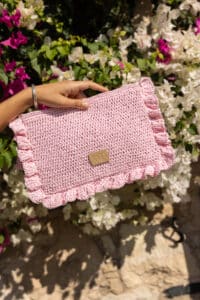 aphrodite pouch in oleander pink, hand knitted and lined with raw linen