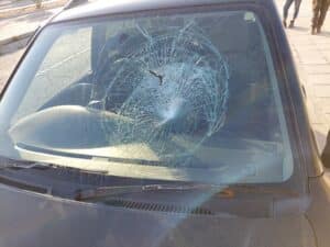 cabs car with completely broken windscreen after an illegal trapper threw a rock towards the activists