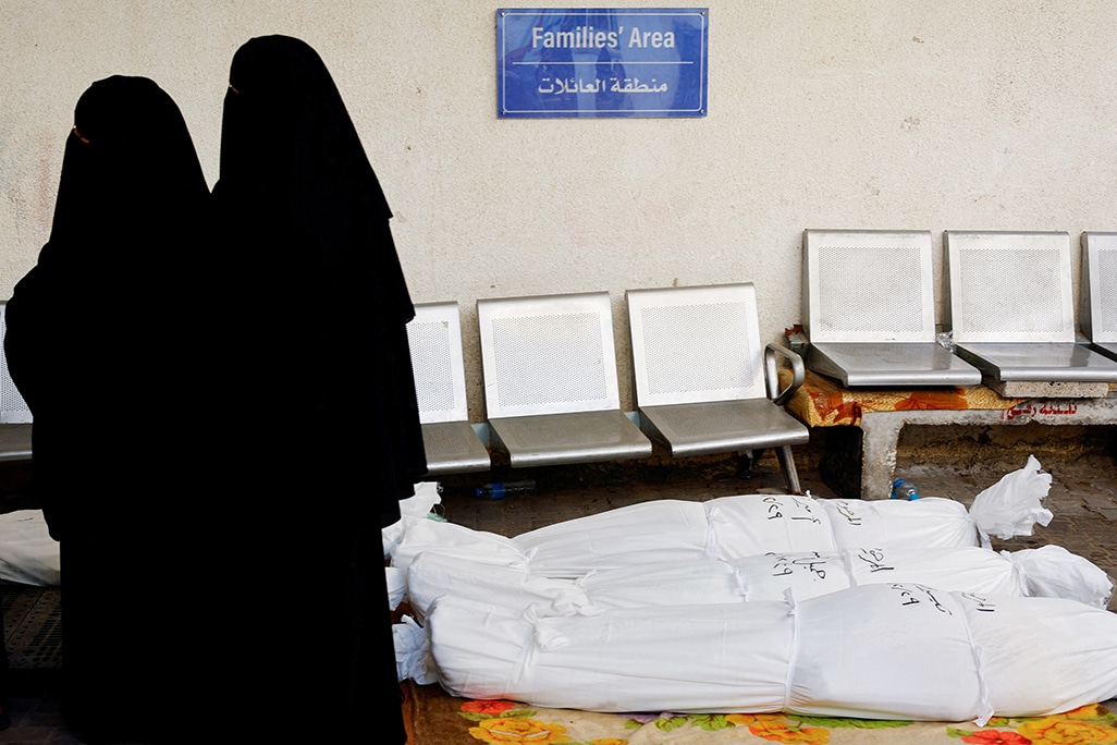 image In Gaza, rows of white shrouds symbolise mounting civilian deaths