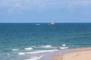 a ship carrying aid sails off the shore of gaza, as seen from central gaza strip