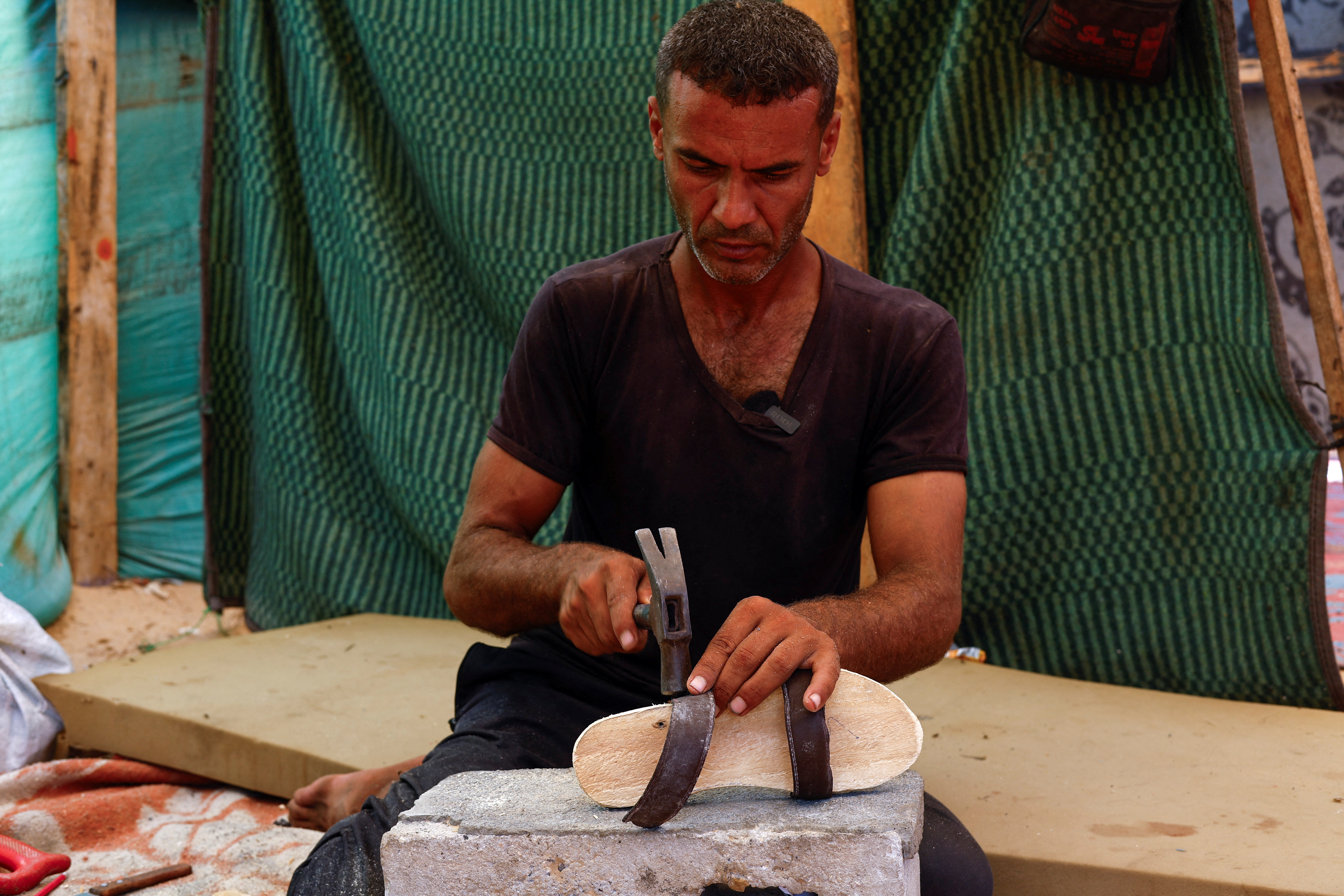 image Gaza carpenter crafts wooden sandals for daughters as war rages