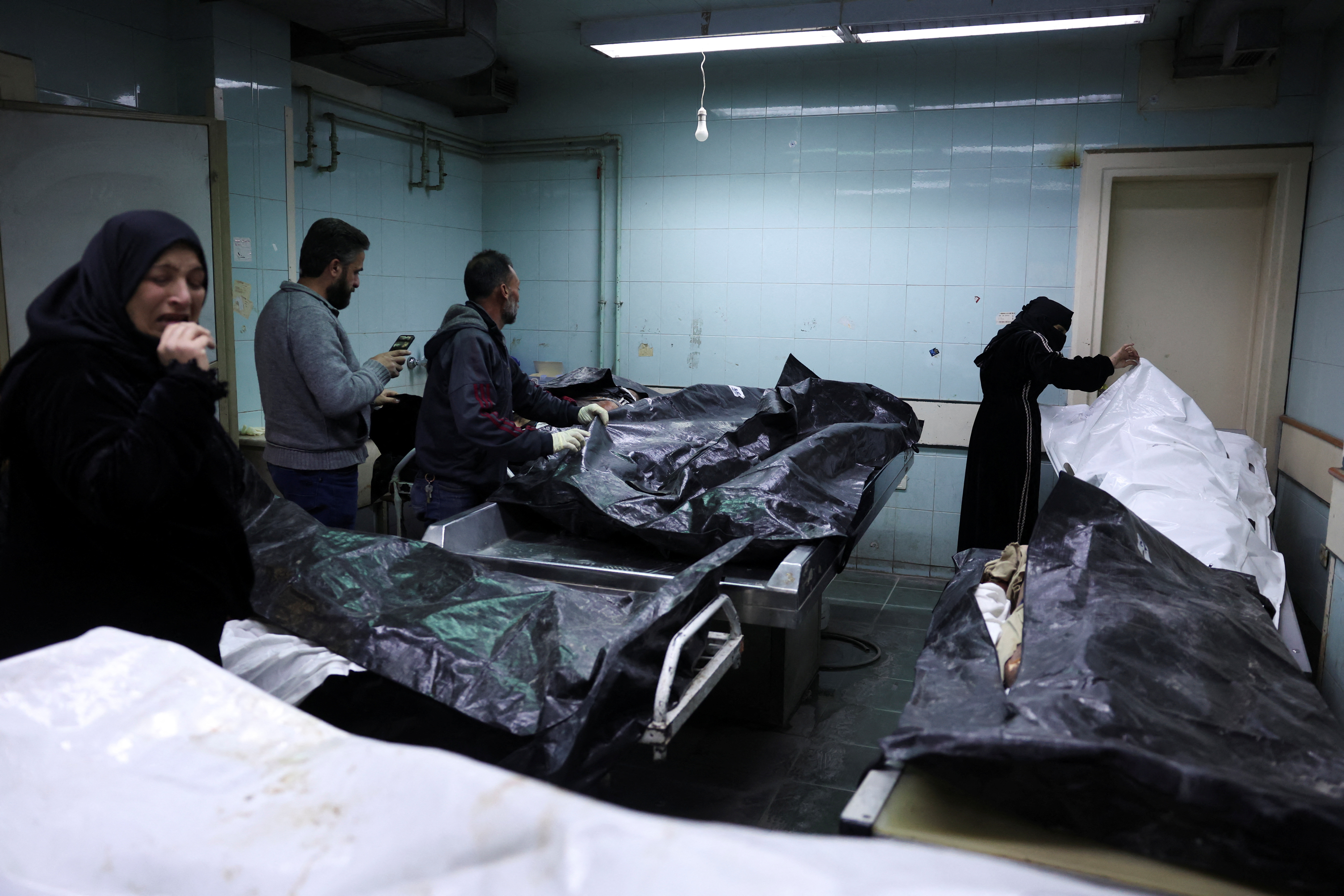 image Syrians scour disfigured corpses for signs of detained loved ones