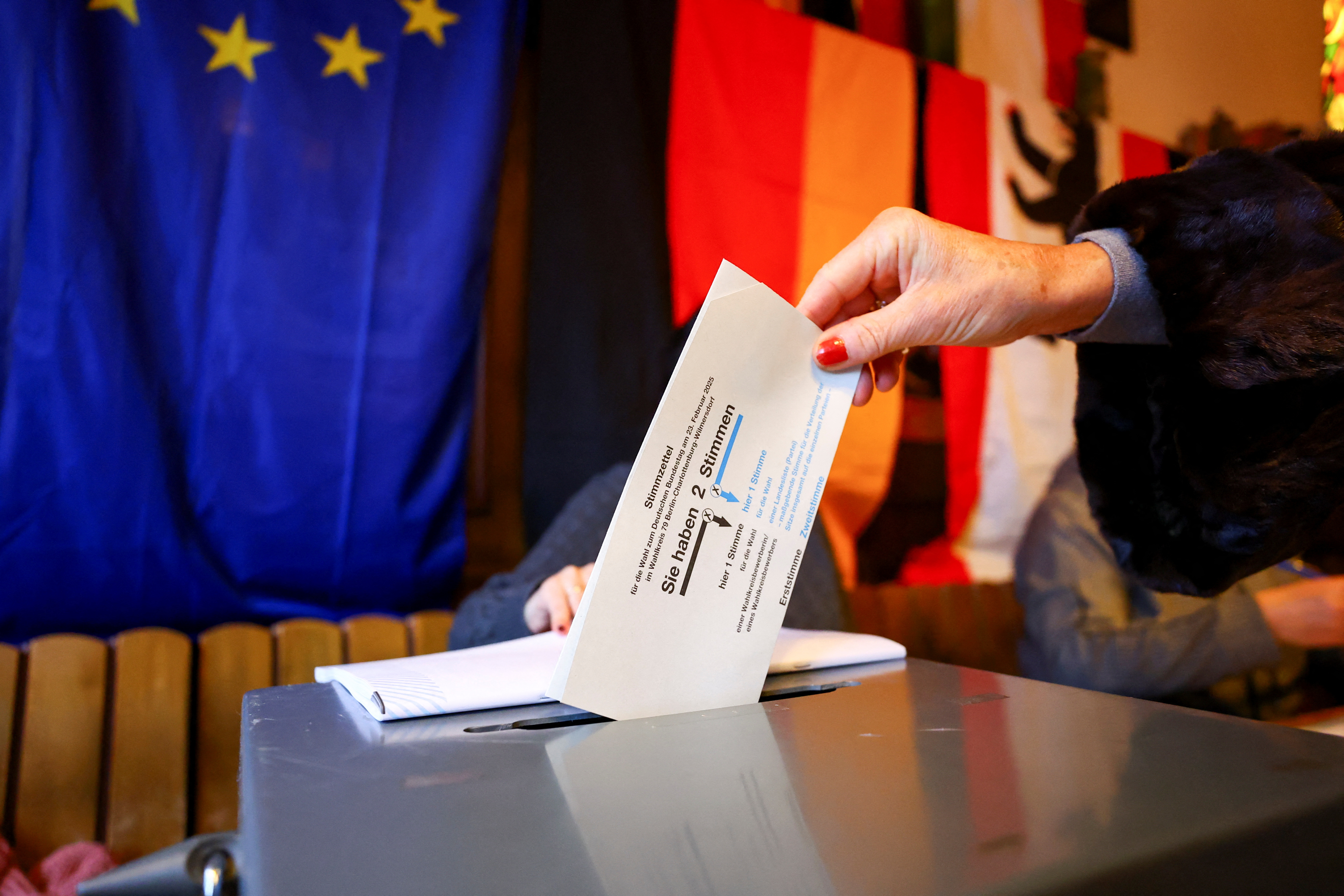 image Germans start voting, polls suggest shift to right