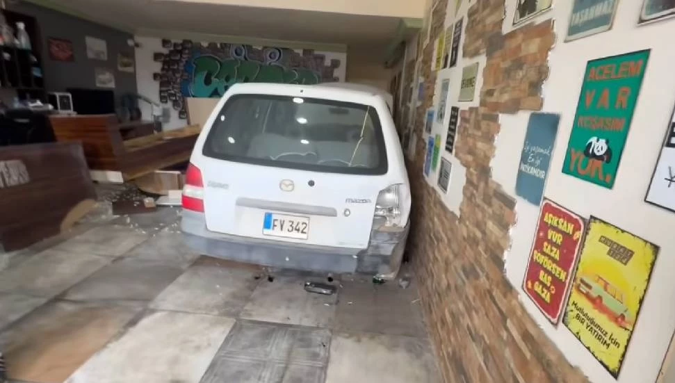 image Man crashes car through barber shop door